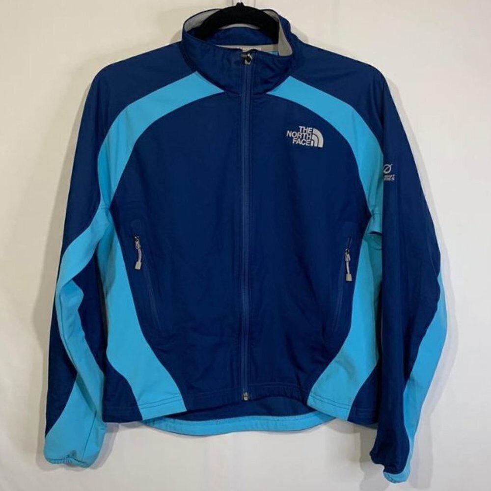 THE North face woman’s running jacket. Hidden pockets, reflective logo. Blue on